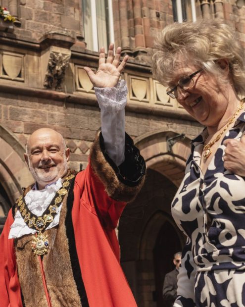 Cllr Brittain waving to the crowds