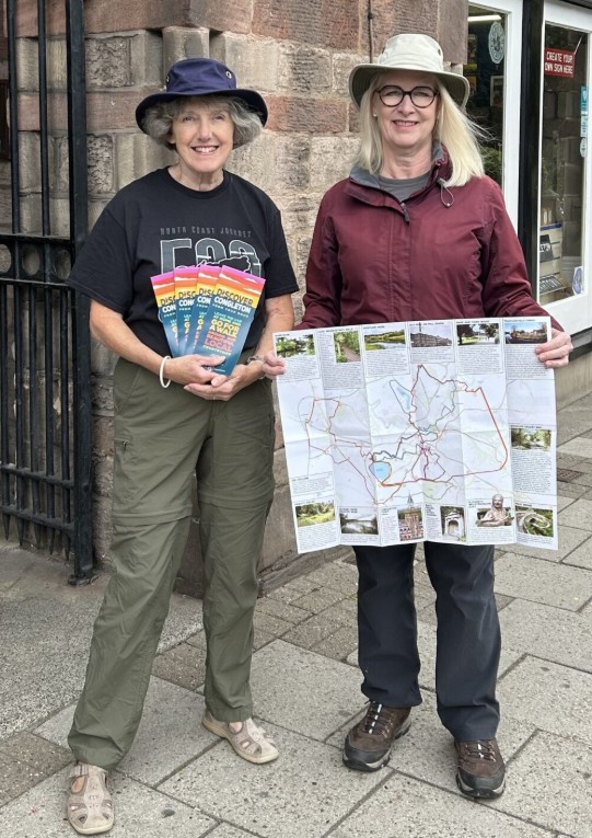 Cll Kay Wesley and Heather Watson holding the Discover Congleton Walking Leaflet